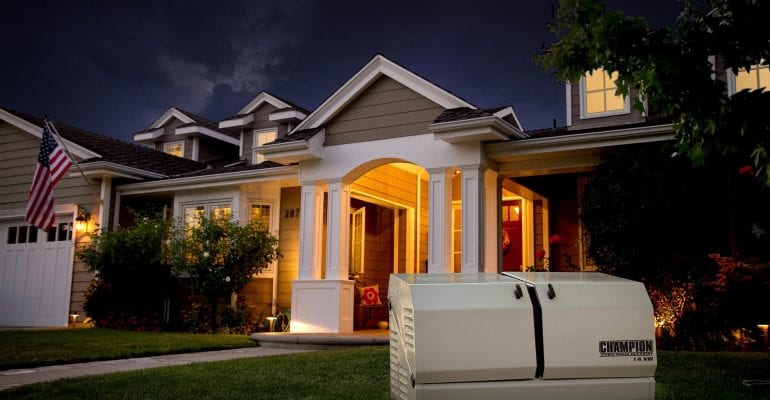 Champion residential generator in the foreground of a private, suburban home at night.