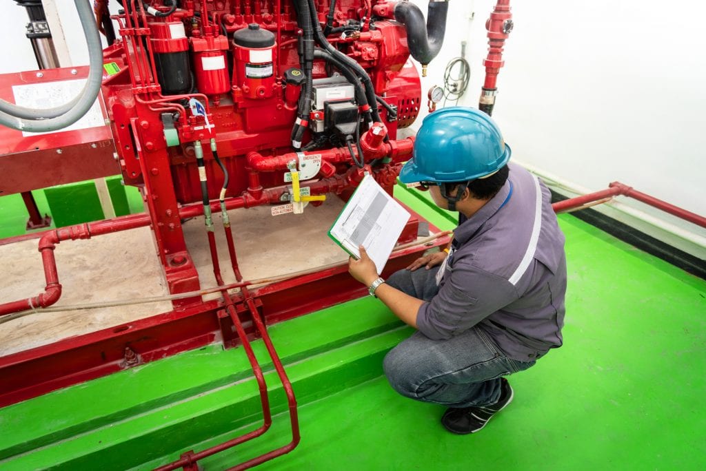 Engineer checking industrial generator fire control system, Diesel engine fire pump controller